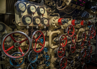Circular pressure valves and gauges in control room inside submarine