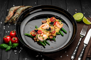 Omelet with shrimp, caviar and grilled tomatoes on a bed of green beans and bacon