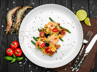 Omelet with shrimp, caviar and grilled tomatoes on a bed of green beans and bacon