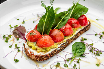 Delicious bruschetta with cream cheese, gluacomoli sauce and cherry tomatoes