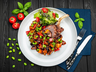 grilled pork steak with a bone in a sweet honey glaze and vegetable stew with green beans