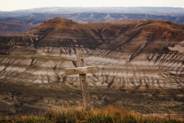 Wooden cross memorial over hills in Wyoming