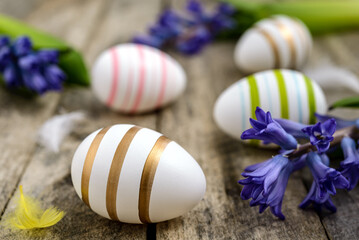 Easter eggs and flowers on wooden background