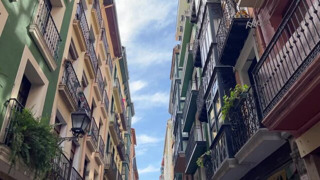 View of residential buildings while walking on Bilbao old town street. Real estate business, classic architecture style, tourism concepts