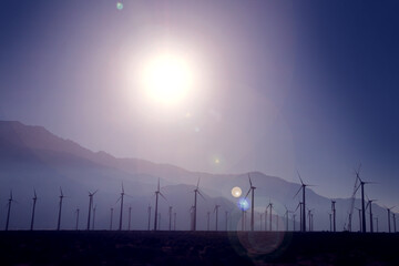 desert wind farm turbines purple mountains dusk valley windy sunny canyon renewable electricity energy power turbines
