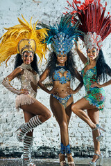 The beautiful women that keep the night alive. Shot of beautiful samba dancers posing against a...