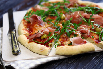 Italian pizza with jamon and arugula. Homemade pizza.