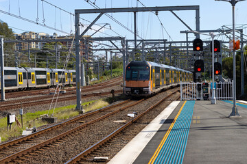 Obraz premium Commuter train approaching at a train station in Sydney NSW Australia blurred background 