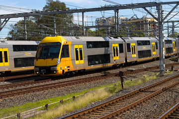 Commuter train approaching at a train station in Sydney NSW Australia blurred background 