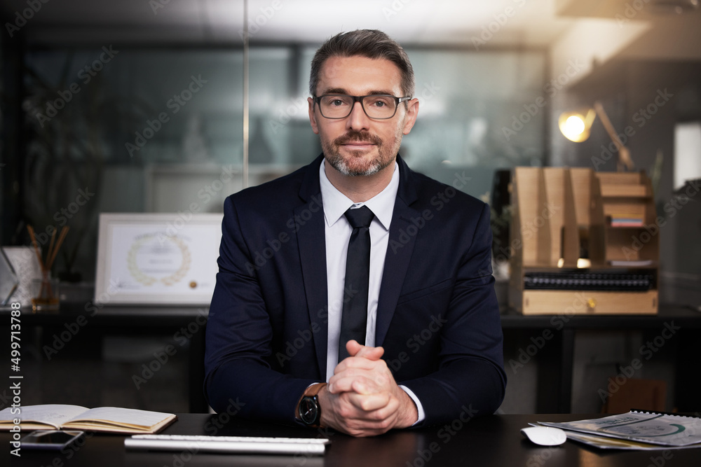 Wall mural You have to take the risk or lose the chance. Portrait of a mature businessman sitting at his desk.