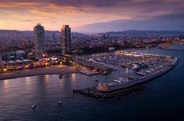Aerial view of seaside area of Barcelona overlooking two modern skyscrapers on Mediterranean coast...