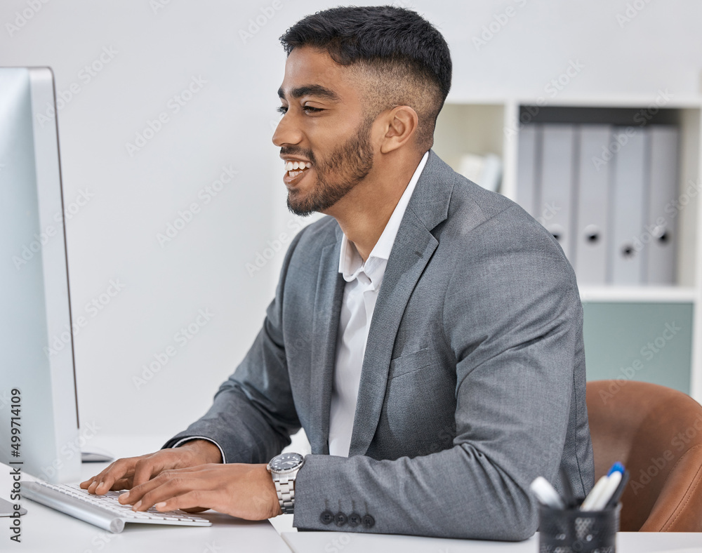 Poster Always working hard to get it all done. Shot of a young businessman working on a computer in an office.