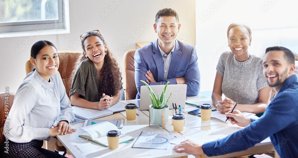 Poster were happy to be working together. shot of a group of colleagues having a meeting in a boardroom at 