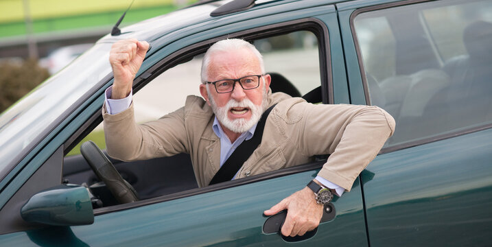 Angry senior man with bad eyesight driving car and getting into car accident