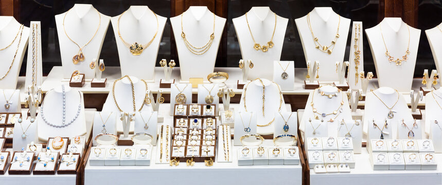 Pendants and bracelets with dimonds on display of jewelry store
