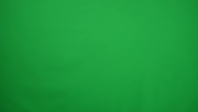Close-up high-five handshake of African American and Caucasian football teammates on green screen. Unrecognizable young sportsmen gesturing saying goodbye leaving chromakey background