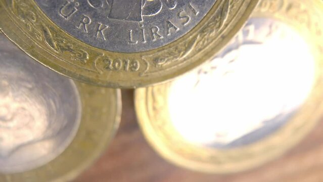 1 Turkish Lira close-up shot. 1 Turkish Lira. Turkish lira on top and bunch of different word currencies rotating, coins on background.
