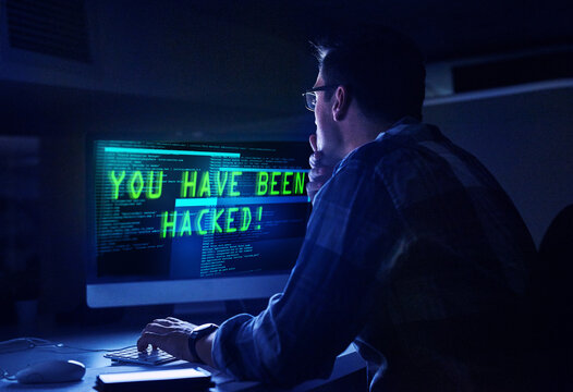 He knows how to handle a hacker. Rearview shot of a young male hacker at work.