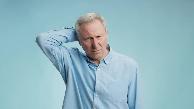 Hard problem. Pensive senior grey haired man thinking over solution, scratching his head and frowning face