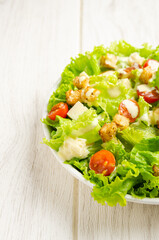 Lettuce, tomato and cheese salad, croutons, dressing.