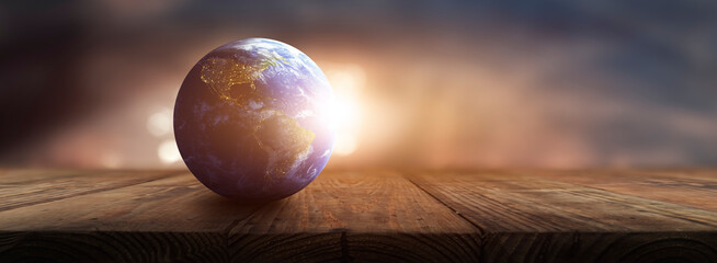 planet earth on on a wooden table - environmental care concept - Elements of this image furnished by NASA