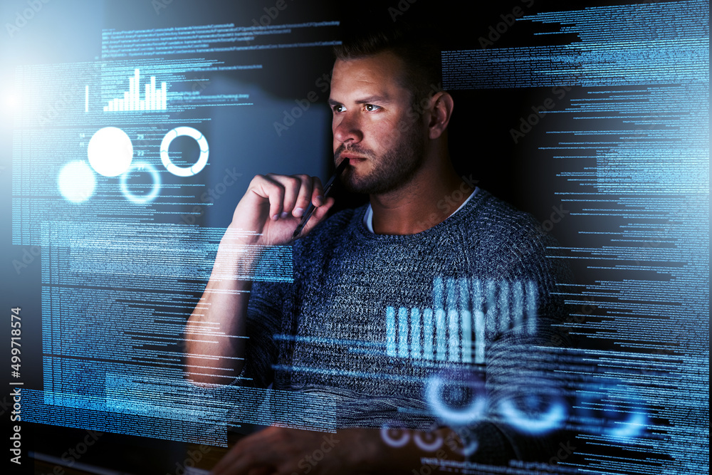Poster Its the perfect job for a night owl. Shot of a focussed computer programmer working at his computer late at night.