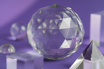 Crystal prism refracting light, magic crystals and pyramid, sphere and cube on purple background....