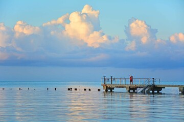 Calm morning sunrise over pier at Higgs Beach in Key West, Florida. 