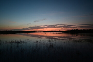 Sunrise cloudscape reflected in calm water of Nine Mile Pond in Everglades National Park, Florida in April.