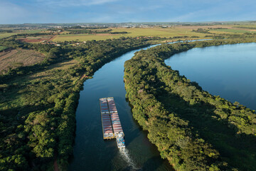 grain transport barge going up the tiete river - tiete-parana waterway - obrazy, fototapety, plakaty