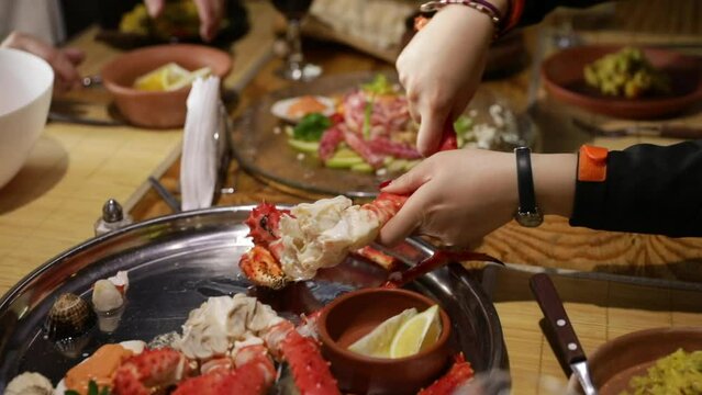 People eating crab legs at the restaurant.