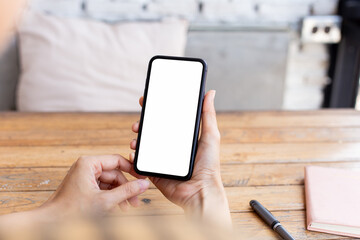 cell phone blank white screen mockup.hand holding texting using mobile on desk at office.background empty space for advertise.work people contact marketing business,technology