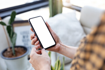 cell phone blank white screen mockup.hand holding texting using mobile on desk at office.background empty space for advertise.work people contact marketing business,technology