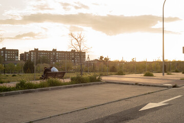 Young friends drinking outside at sunset park