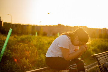 Young latina female sitting at sunset park