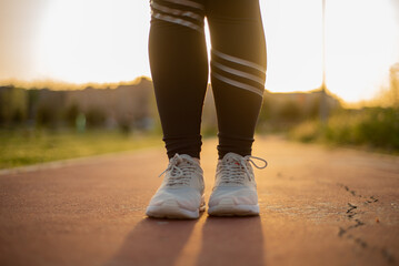 Young female running outside at sunset 