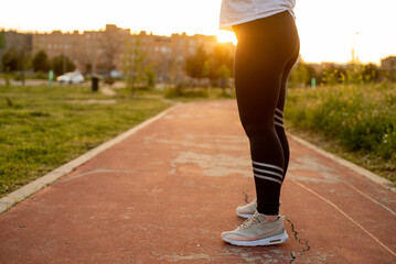 Young female running outside at sunset 