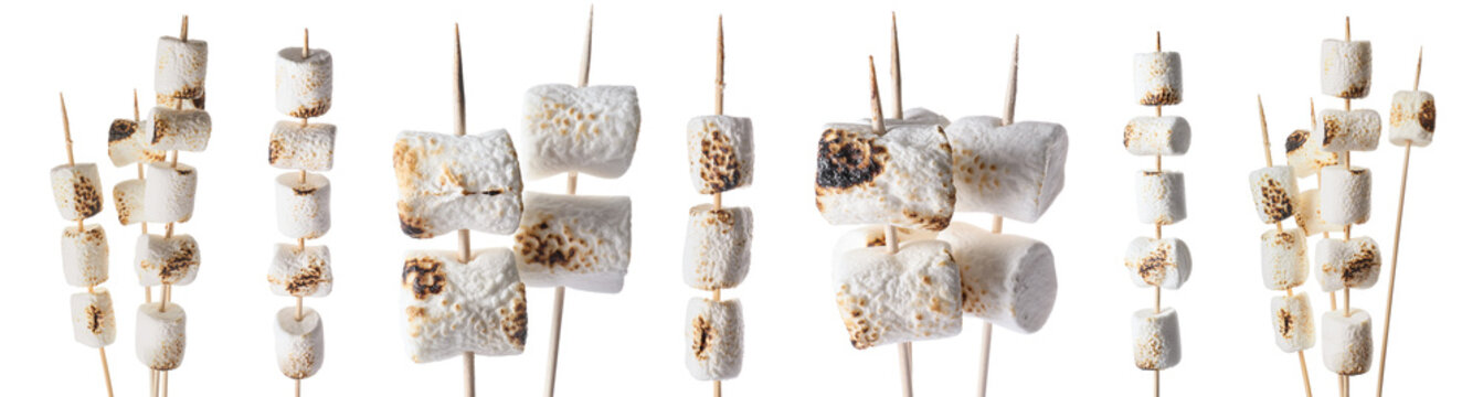 Skewers with delicious roasted marshmallows isolated on white