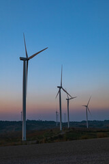 Obraz premium Wind turbines on mountain landscape. Road through mountains wind farm eco. Green ecological power energy concept.