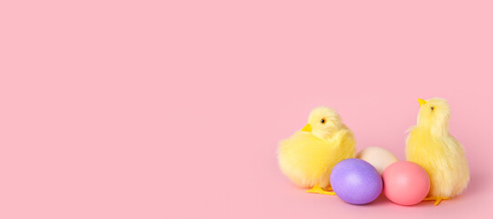 Cute yellow chickens and Easter eggs on pink background with space for text