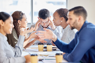 This day is too demanding. Shot of a young businessman looking stressed out in a meeting at work.