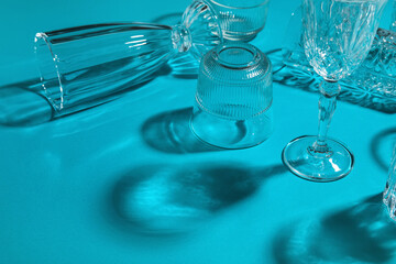 Different empty glasses on blue background