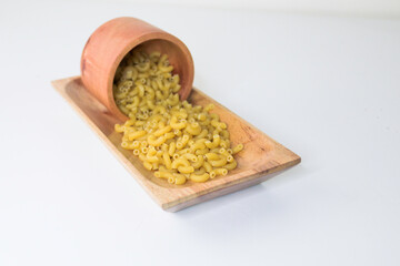 Top view of raw macaroni on white background.