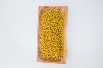 Top view of raw macaroni on white background.