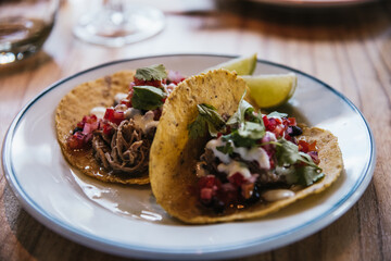 person eating mexican taco in restaurant