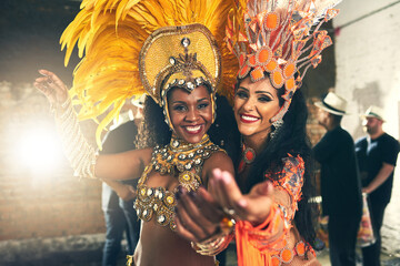 We live to perform. Cropped portrait of two beautiful samba dancers performing at Carnival with their band. - obrazy, fototapety, plakaty