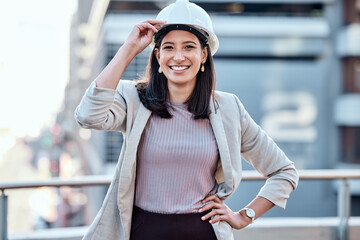 If you wear the hardhat then youre doing hard work. Shot of a young businesswoman wearing a hardhat...