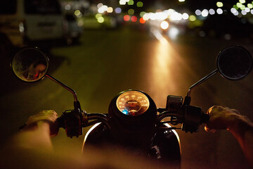 When the sun goes down his bike comes out. POV shot of a man riding a motorbike at night.