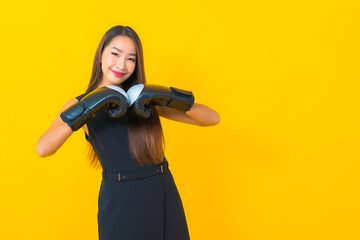 Portrait beautiful young asian business woman with boxing glove