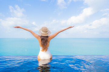 Portrait beautiful young asian woman relax smile leisure around outdoor swimming pool